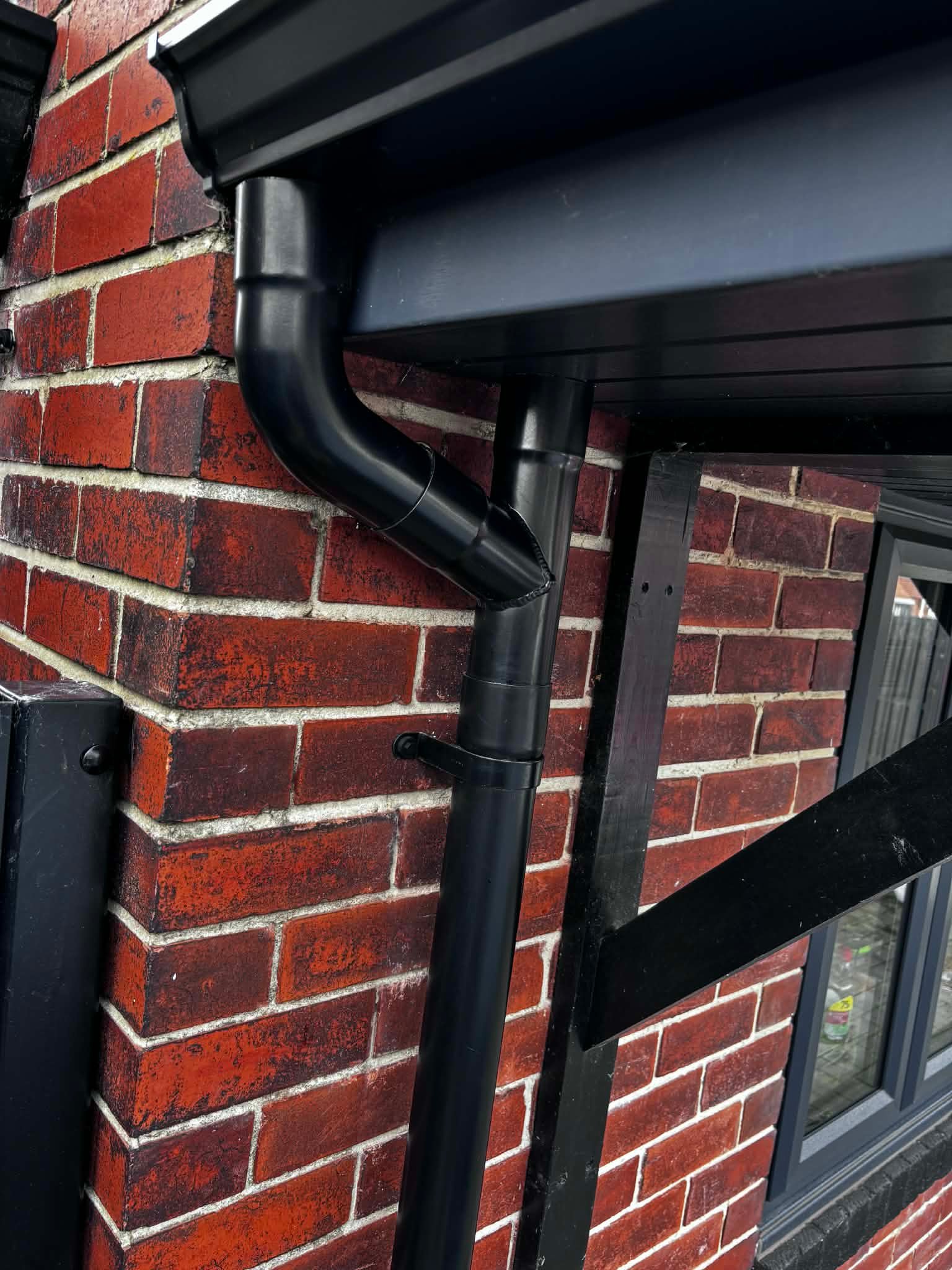Downpipe installed on property exterior