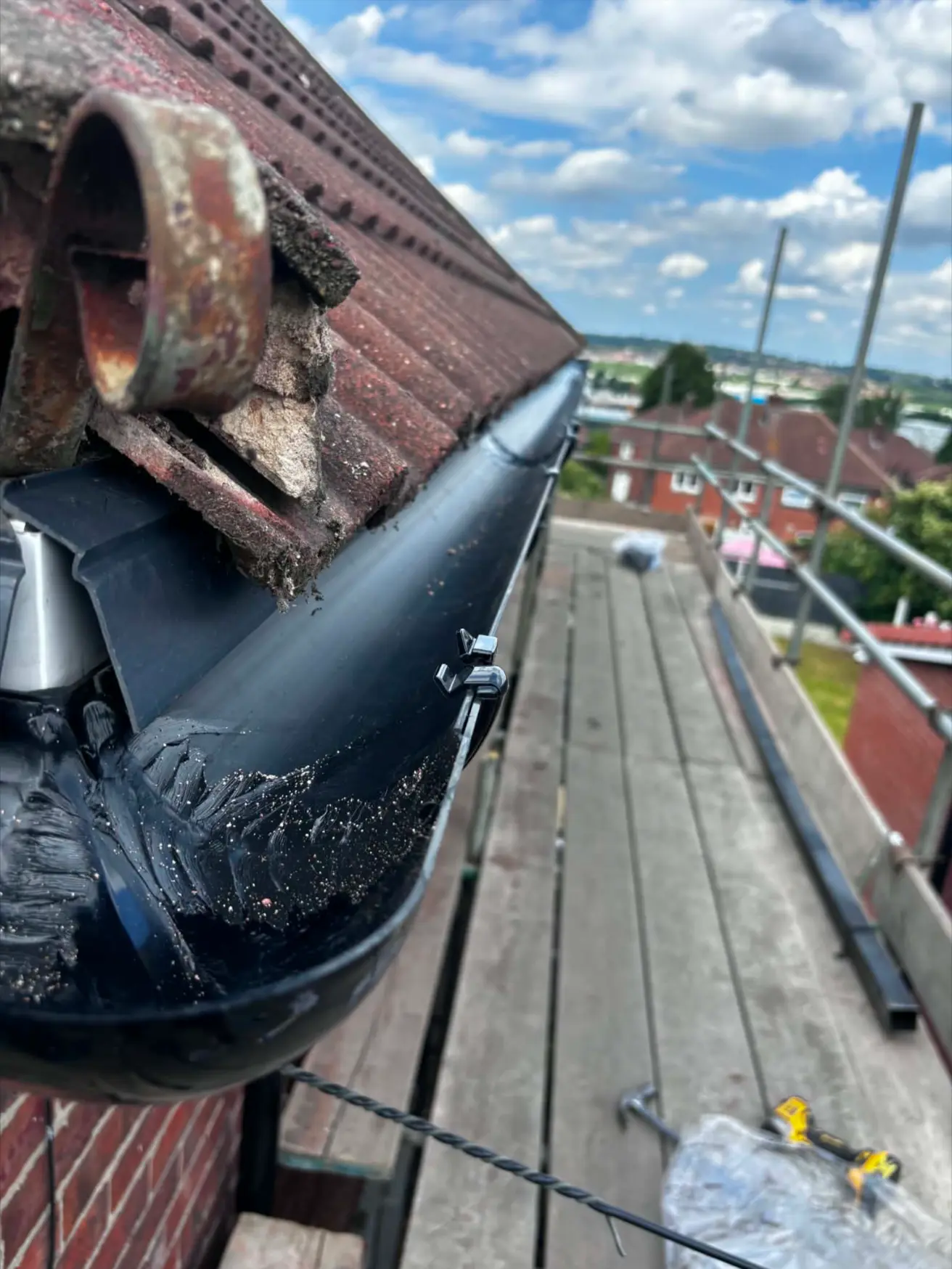 Renewed black gutter run following installation work