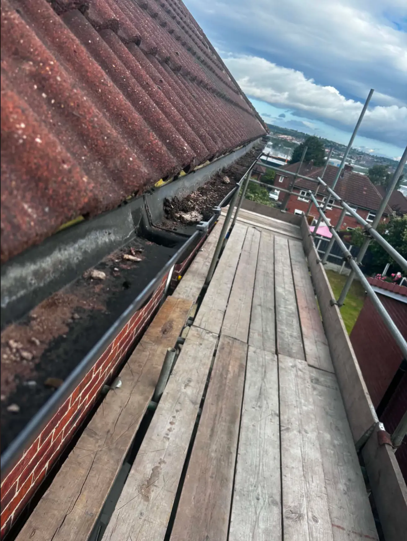 Old gutter run containing debris before renewal
