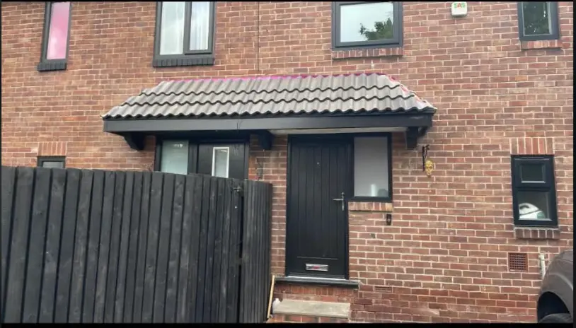 Entrance porch roof before new guttering and downpipe installation